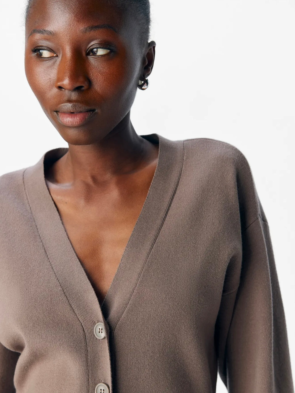 Woman wearing a brown cardigan on a white background