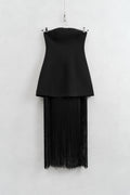 Black strapless top with fringe skirt on a hanger against a white background